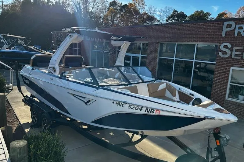 The Image of 2023 Tigé Z3 boat on trailer outside dealership, sunny day. - 1