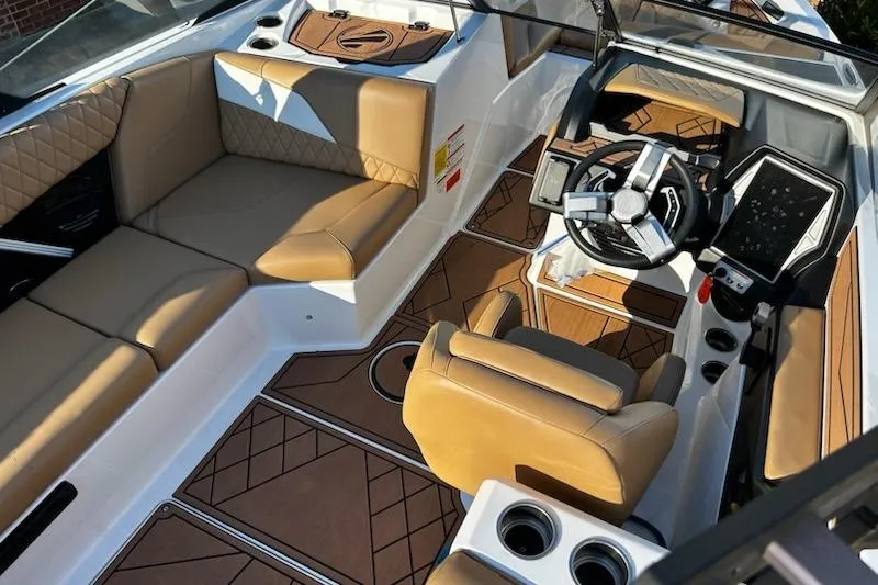 Slide: The Image of 2023 Tigé Z3 boat interior with tan upholstery and modern dashboard. - 10