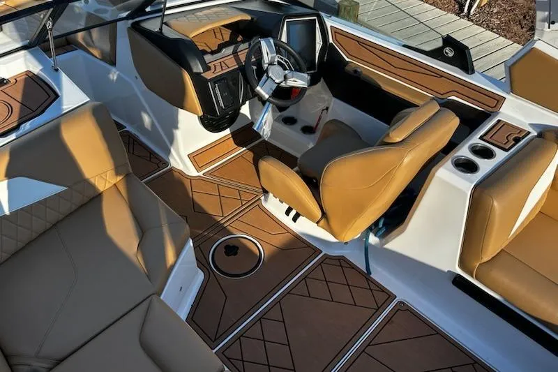 Slide: The Image of 2023 Tigé Z3 boat interior with tan leather seats and modern dashboard. - 11