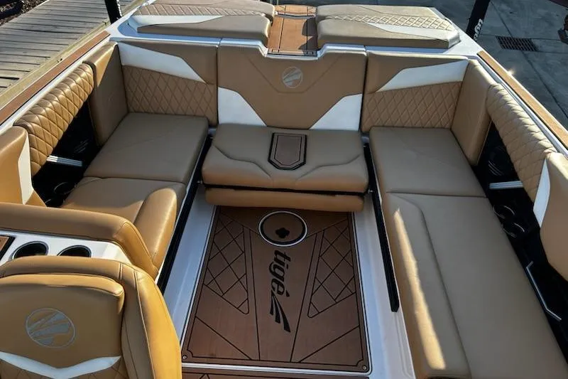 Slide: The Image of 2023 Tigé Z3 boat interior with tan leather seating and custom flooring. - 12