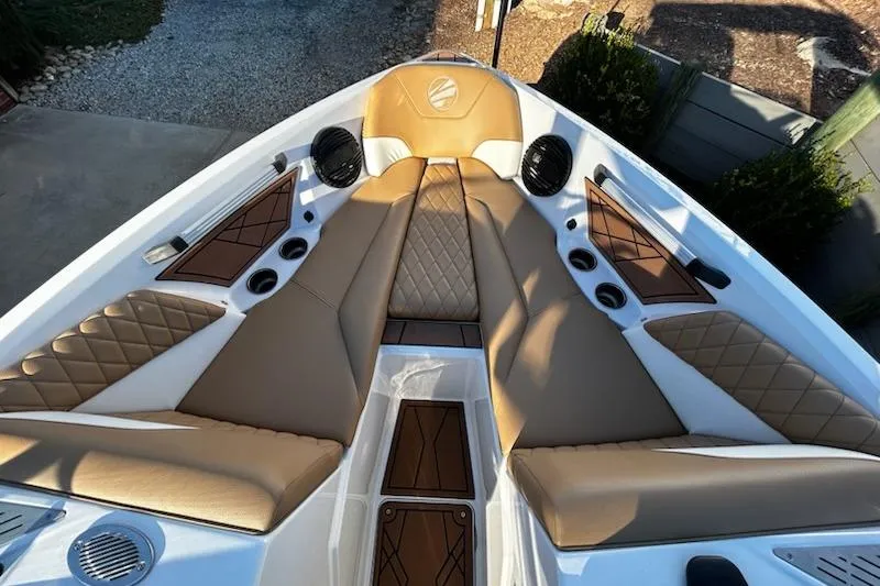 Slide: The Image of 2023 Tigé Z3 boat interior with tan and white seating, diamond stitching, and cup holders. - 14