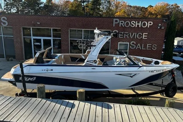 Slide: The Image of 2023 Tigé Z3 boat displayed at a dealership, showcasing sleek design and modern features. - 2