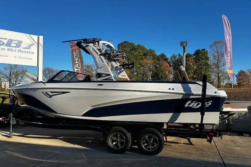 Slide: The Image of 2023 Tigé Z3 boat on trailer at dealership, clear sky background. - 6