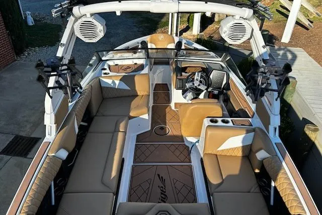 Slide: The Image of 2023 Tigé Z3 boat interior with tan seating and advanced audio system. - 9