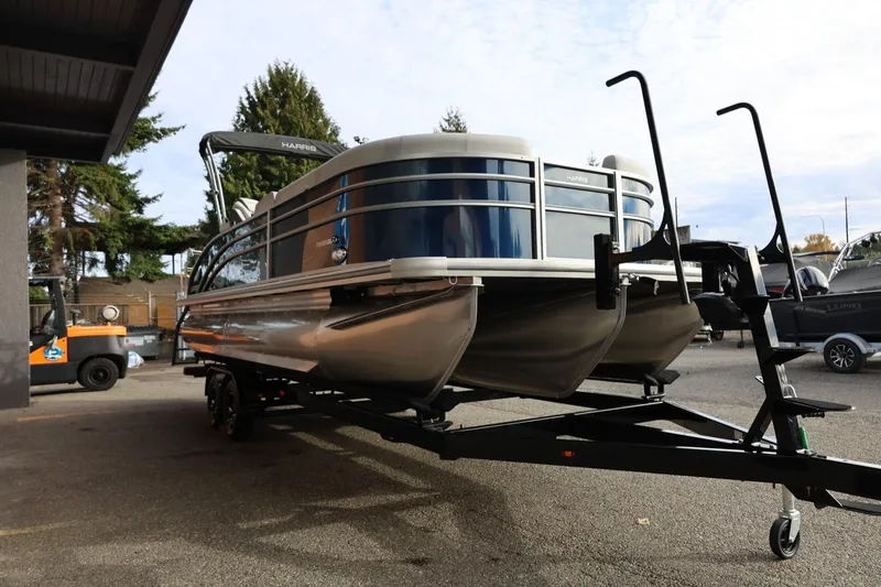 Slide: The Image of 2026 Harris CRUISER 230 SL pontoon boat on trailer, parked outdoors. - 10