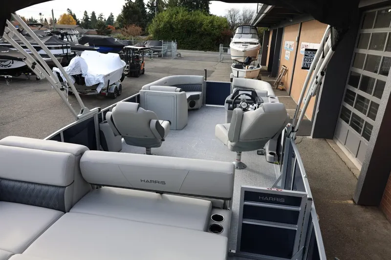 Slide: The Image of 2026 Harris CRUISER 230 SL pontoon boat interior with seating and steering console. - 18