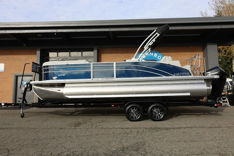 Slide: The Image of 2026 Harris CRUISER 230 SL pontoon boat on trailer, parked outdoors. - 2