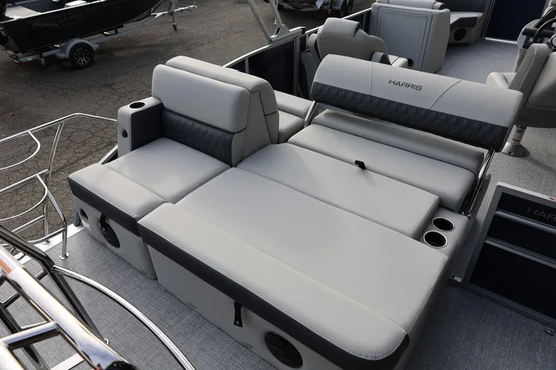 Slide: The Image of 2026 Harris CRUISER 230 SL boat interior with luxurious gray seating and cup holders. - 21