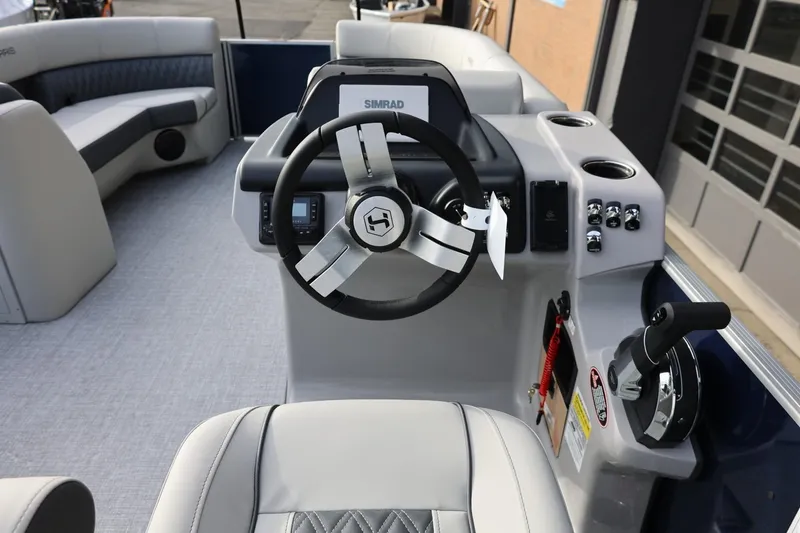 Slide: The Image of 2026 Harris CRUISER 230 SL boat interior with steering wheel and control panel. - 27