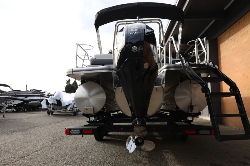 Slide: The Image of 2026 Harris CRUISER 230 SL pontoon boat on trailer, rear view with outboard motor. - 6