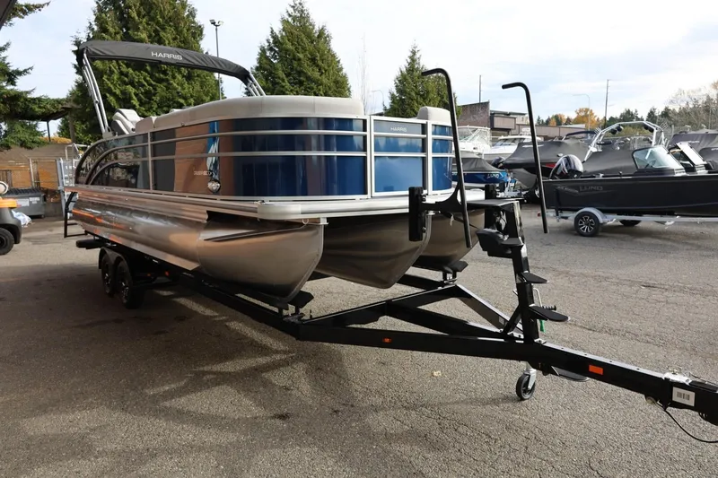 Slide: The Image of 2026 Harris CRUISER 230 SL pontoon boat on trailer, parked outdoors. - 9