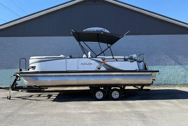 The Image of 2026 Avalon 2385 LSZ QLS pontoon boat on trailer, parked outdoors. - 0