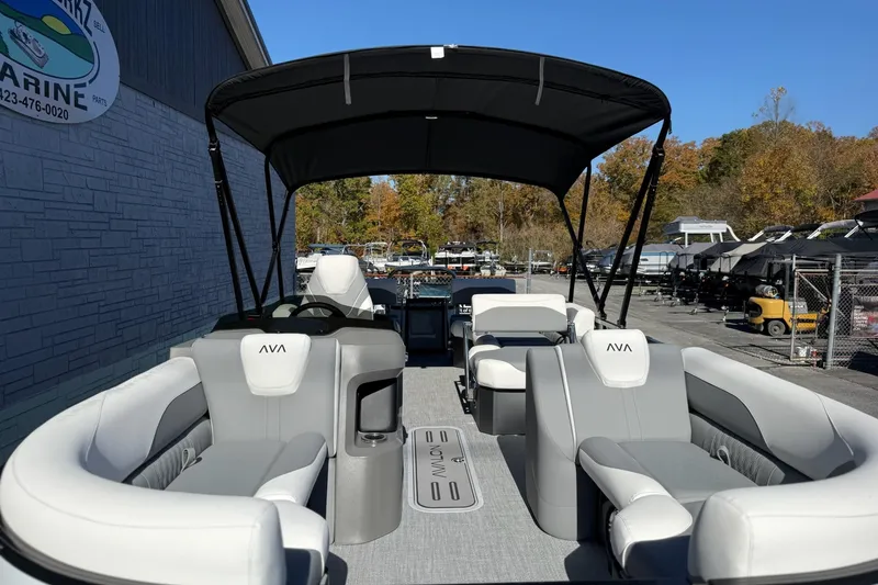 Slide: The Image of 2026 Avalon 2385 LSZ QLS pontoon boat with sleek seating and canopy, docked outdoors. - 16