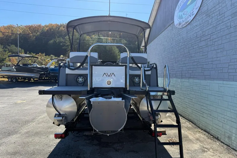 Slide: The Image of 2026 Avalon 2385 LSZ QLS pontoon boat, rear view, parked near a marine shop. - 4