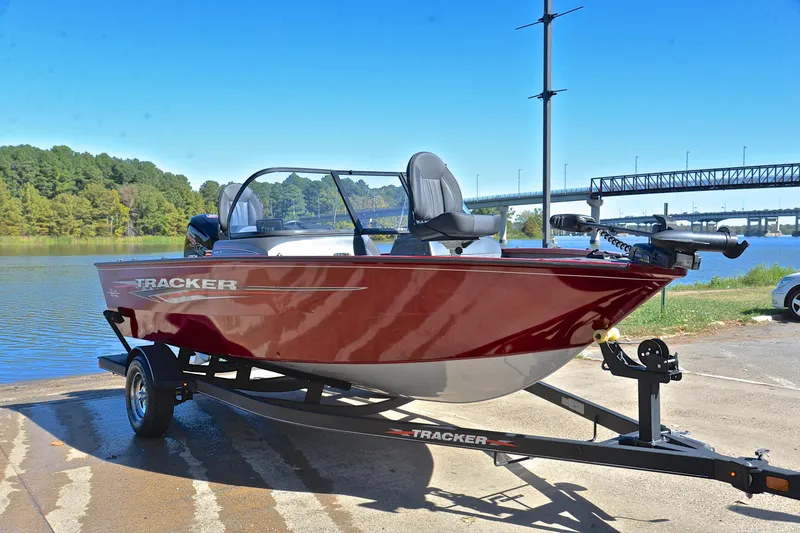 Slide: The Image of 2022 Bass Tracker Pro Guide V175 WT boat on trailer by a scenic lake. - 16