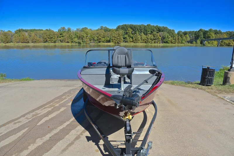Slide: The Image of 2022 Bass Tracker Pro Guide V175 WT boat at a lakeside launch ramp. - 17
