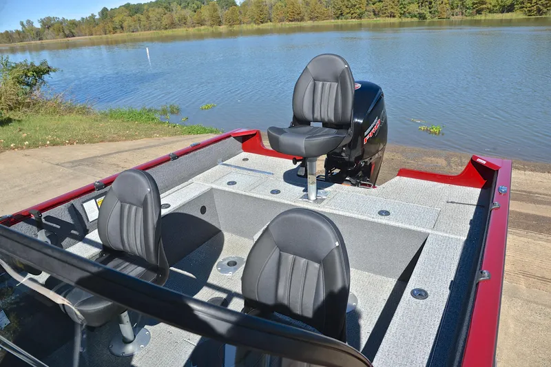 Slide: The Image of 2022 Bass Tracker Pro Guide V175 WT boat with seating, docked by a serene lake. - 21