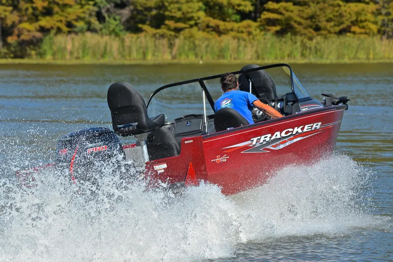 Slide: The Image of 2022 Bass Tracker Pro Guide V175 WT boat speeding on a lake with splashing water. - 5
