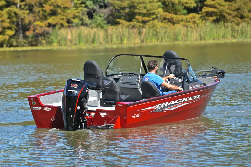Slide: The Image of 2022 Bass Tracker Pro Guide V175 WT boat on a serene lake. - 8