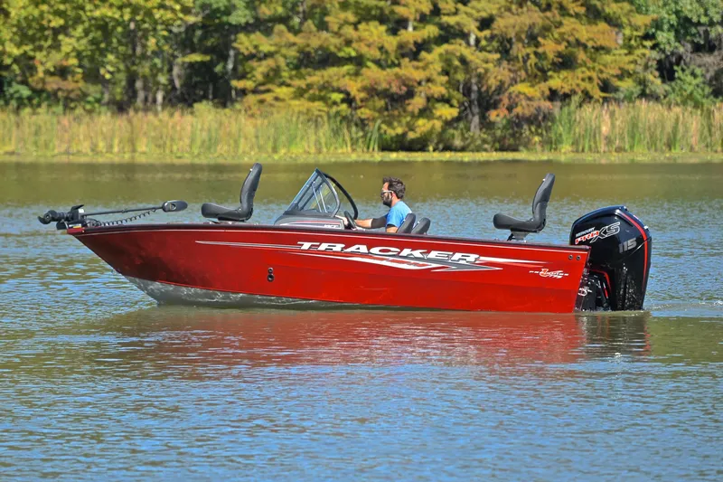 Slide: The Image of 2022 Bass Tracker Pro Guide V175 WT boat on a calm lake. - 9
