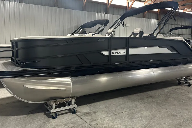 Slide: The Image of 2026 Evotti 723 CS pontoon boat in a warehouse, showcasing sleek design and modern features. - 1