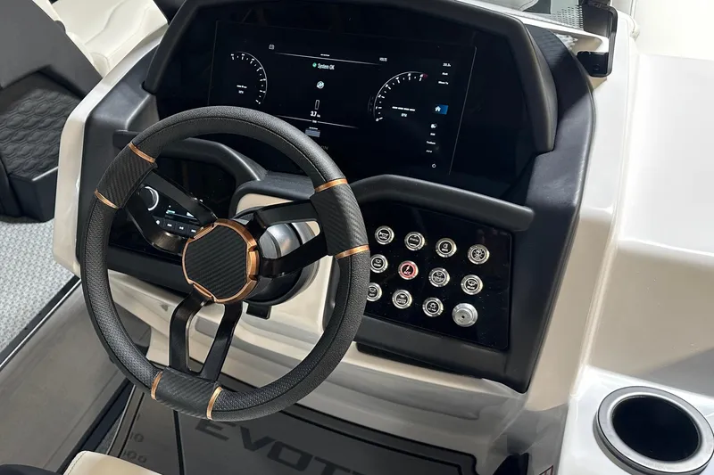 Slide: The Image of Steering wheel and dashboard of 2026 Evotti 723 CS boat, featuring modern controls and display. - 15