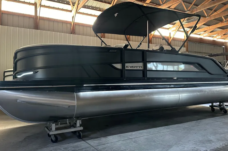 Slide: The Image of 2026 Evotti 723 CS pontoon boat in a warehouse, featuring sleek design and canopy. - 22