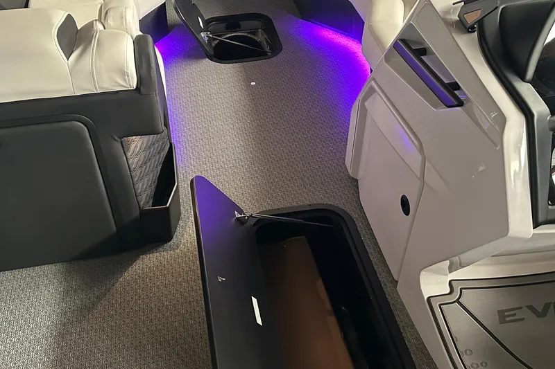 Slide: The Image of Interior of 2026 Evotti 723 CS boat with purple LED lighting and open storage compartments. - 29