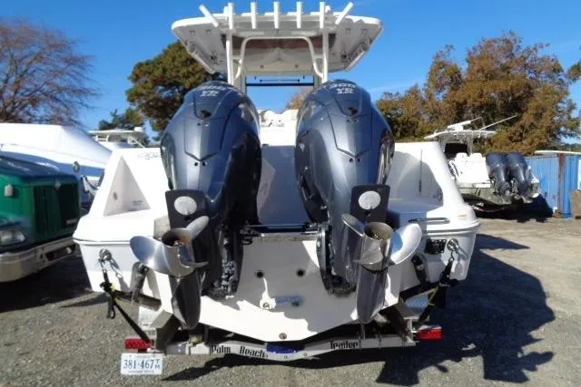 Slide: The Image of 2023 Robalo R302 Center Console with dual outboard engines, rear view. - 10
