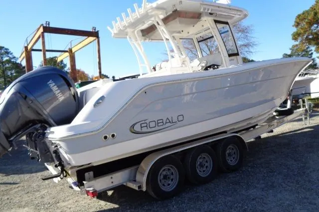 Slide: The Image of 2023 Robalo R302 Center Console boat on a trailer with Yamaha engine. - 11