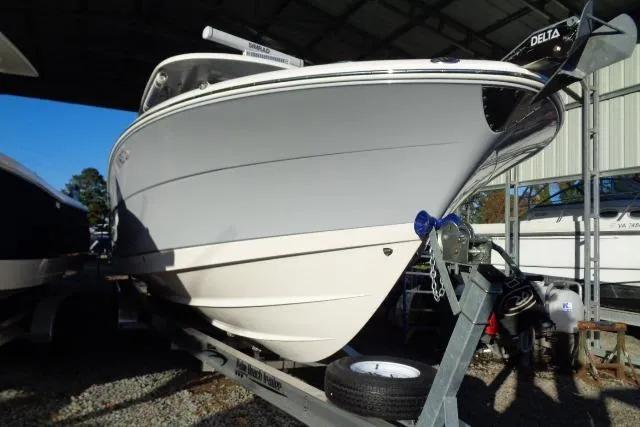 Slide: The Image of 2023 Robalo R302 Center Console boat on trailer in storage facility. - 2