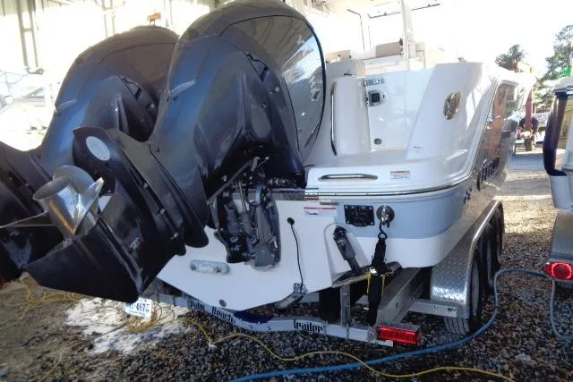 Slide: The Image of 2023 Robalo R302 Center Console boat with dual outboard engines on a trailer. - 4