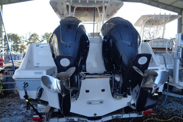 Slide: The Image of 2023 Robalo R302 Center Console boat with dual outboard engines, rear view. - 5