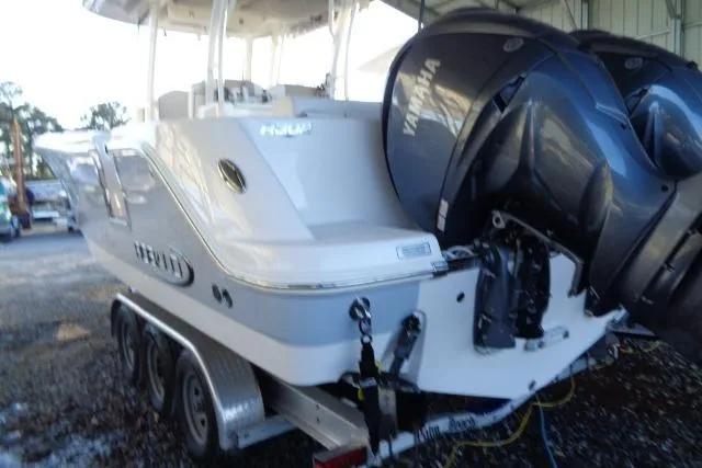 Slide: The Image of 2023 Robalo R302 Center Console boat with Yamaha engines on a trailer. - 6