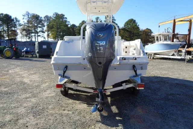 Slide: The Image of 2023 Robalo R302 Center Console boat with powerful outboard motor, parked outdoors. - 8