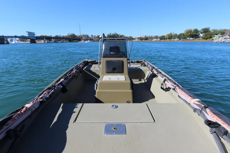 Slide: The Image of 2006 Xpress HD18CC boat on calm water, clear sky, and distant bridge view. - 13