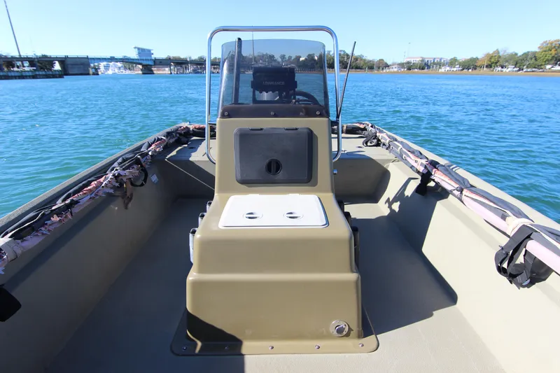 Slide: The Image of 2006 Xpress HD18CC boat on water, featuring center console and open deck. - 14
