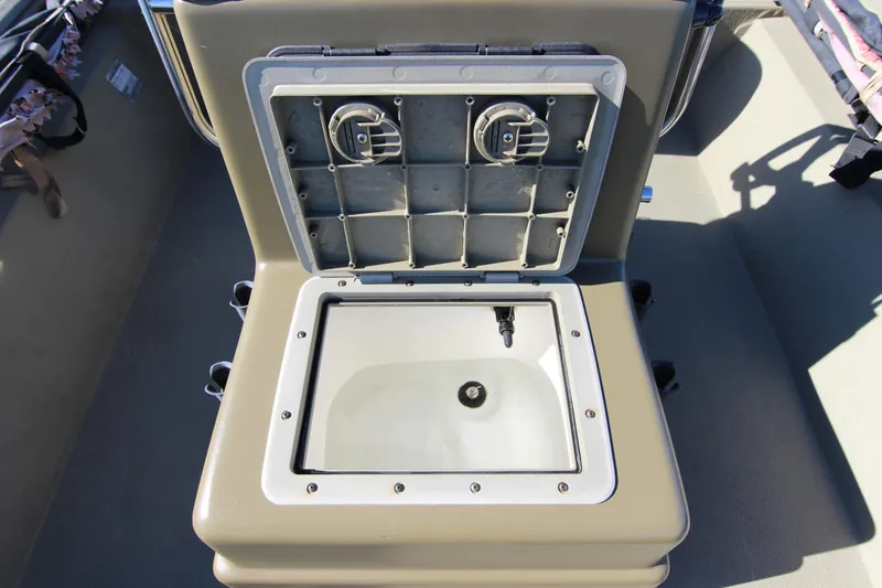 Slide: The Image of Open storage compartment on 2006 Xpress HD18CC boat, showing interior details. - 15