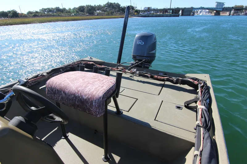 Slide: The Image of 2006 Xpress HD18CC boat on water, featuring Yamaha 90 engine and camo seat. - 16