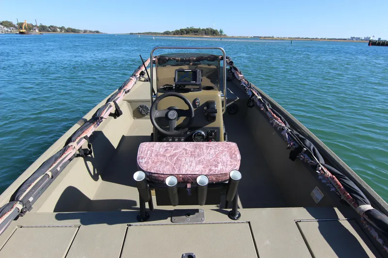 Slide: The Image of 2006 Xpress HD18CC boat interior with steering wheel, seat, and water view. - 20