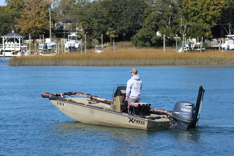 Slide: The Image of Man on 2006 Xpress HD18CC boat with Yamaha motor, cruising on a calm river. - 3