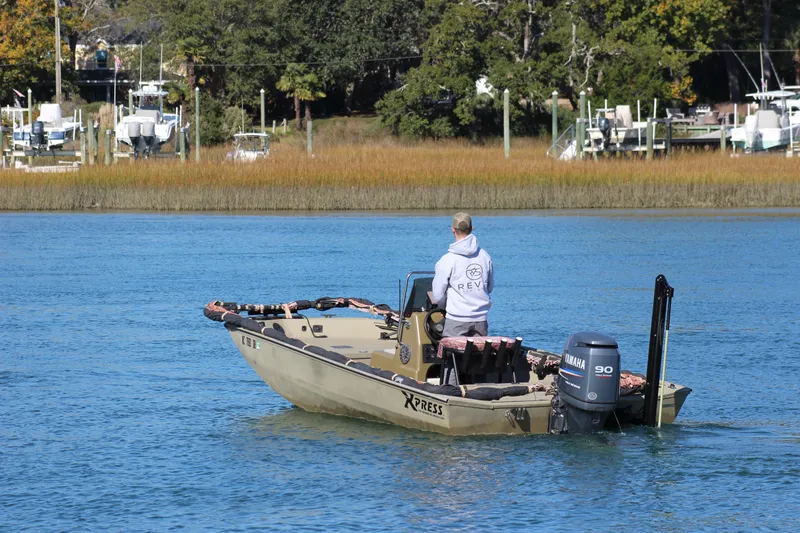 Slide: The Image of Man steering 2006 Xpress HD18CC boat with Yamaha motor on a calm river. - 4