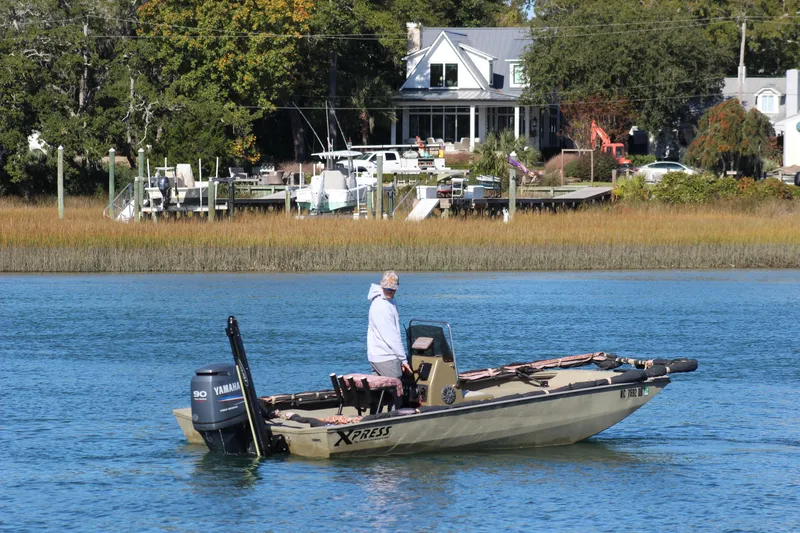Slide: The Image of Man on 2006 Xpress HD18CC boat with Yamaha motor, near waterfront homes. - 6