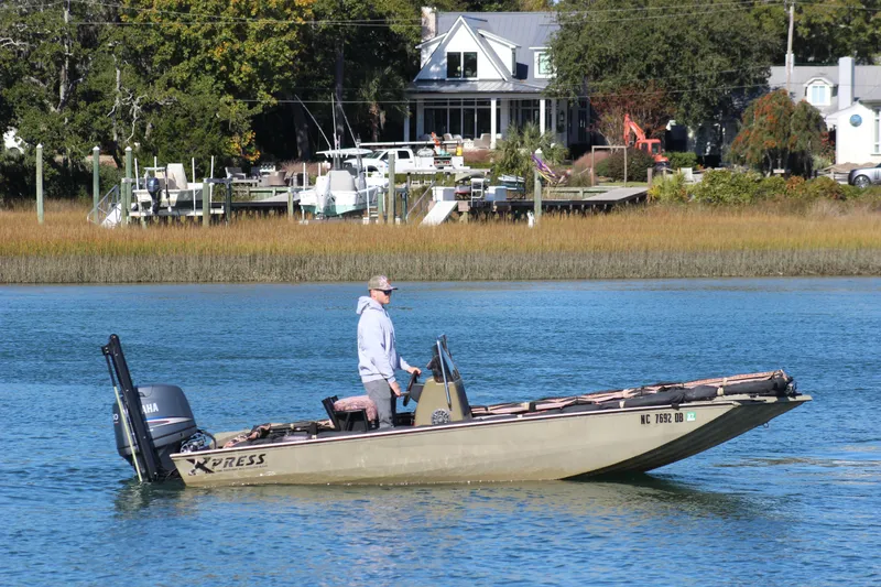Slide: The Image of Man on 2006 Xpress HD18CC boat cruising near waterfront homes. - 7