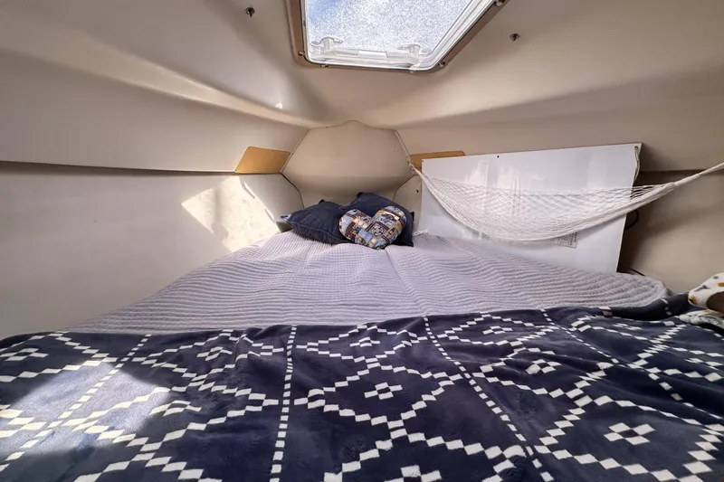 Slide: The Image of Cozy cabin interior of 2000 Hunter 290 sailboat with bed and hammock. - 17