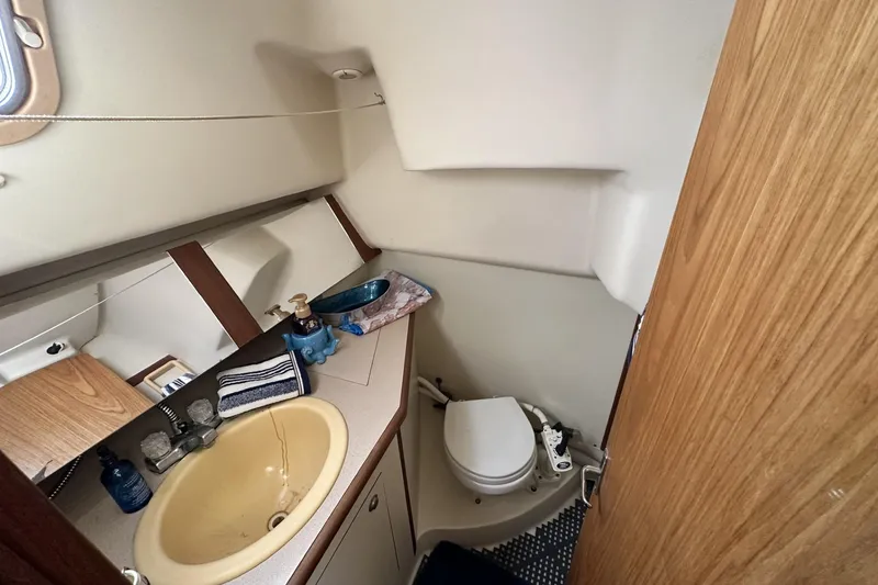 Slide: The Image of Compact bathroom in a 2000 Hunter 290 sailboat with sink and toilet. - 19