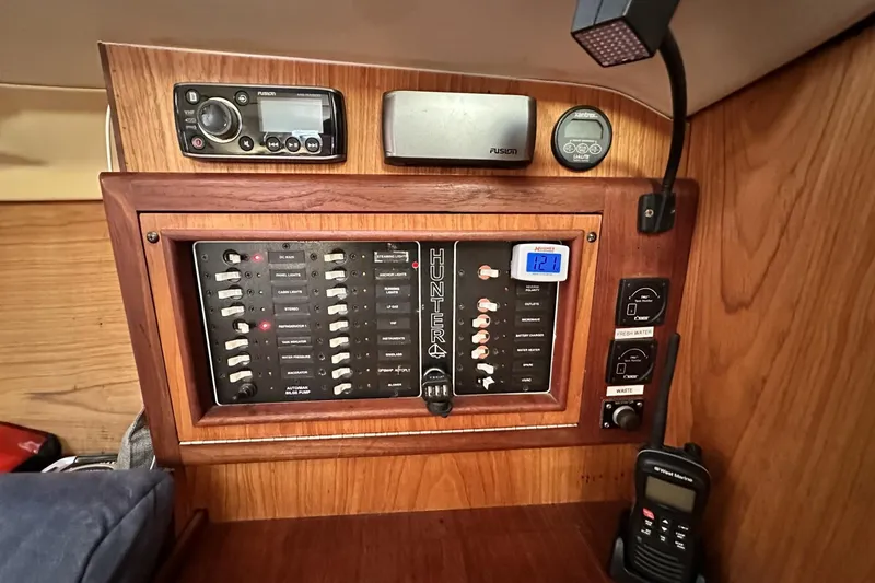 Slide: The Image of Control panel of a 2000 Hunter 290 sailboat with various switches and devices. - 20