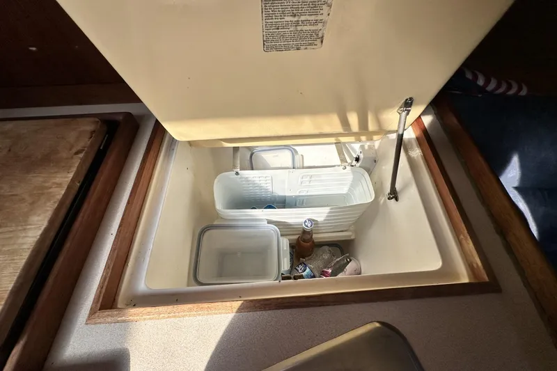 Slide: The Image of Interior view of a 2000 Hunter 290 sailboat's compact refrigerator. - 22
