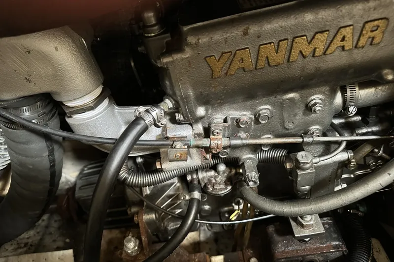 Slide: The Image of Yanmar engine in a 2000 Hunter 290 sailboat, showing detailed components and connections. - 28