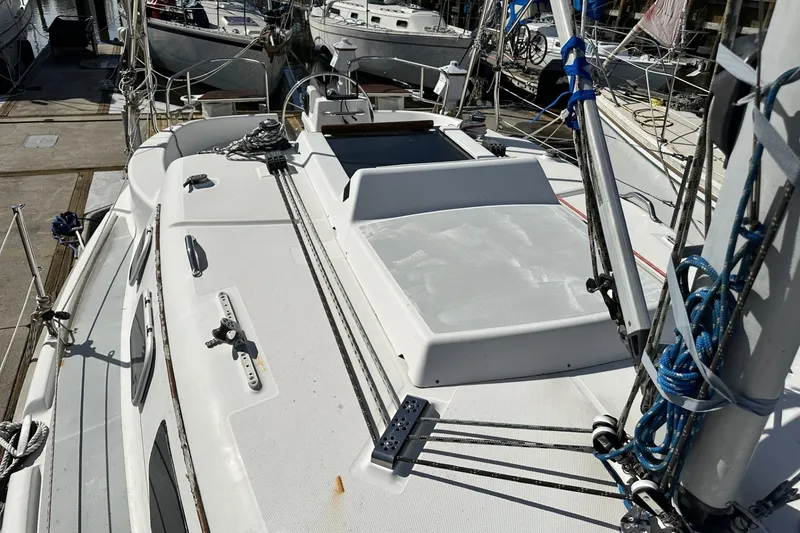 Slide: The Image of 2000 Hunter 290 sailboat deck with rigging, docked at marina. - 3